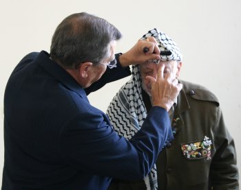 R.T. prays for President Arafat and anoints him with oil.